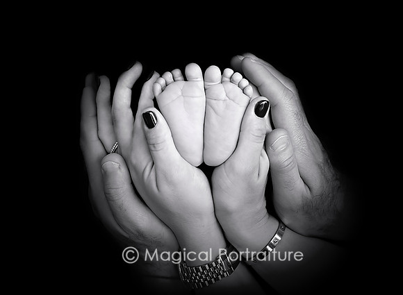 Newborn baby boy photoshoot in parents hands black and white NJ